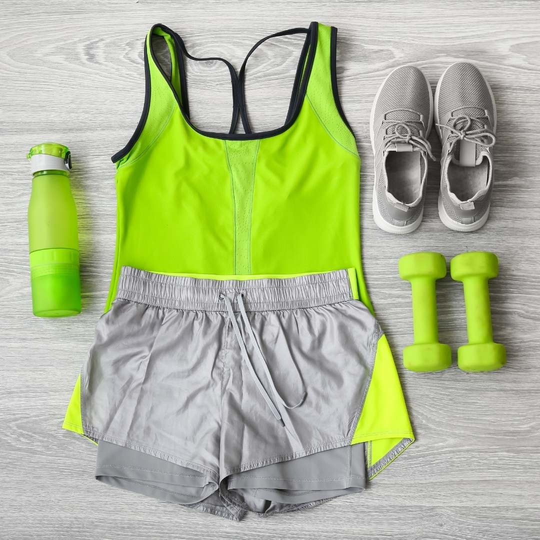 Neon green workout outfit with shoes dumbbells and water bottle